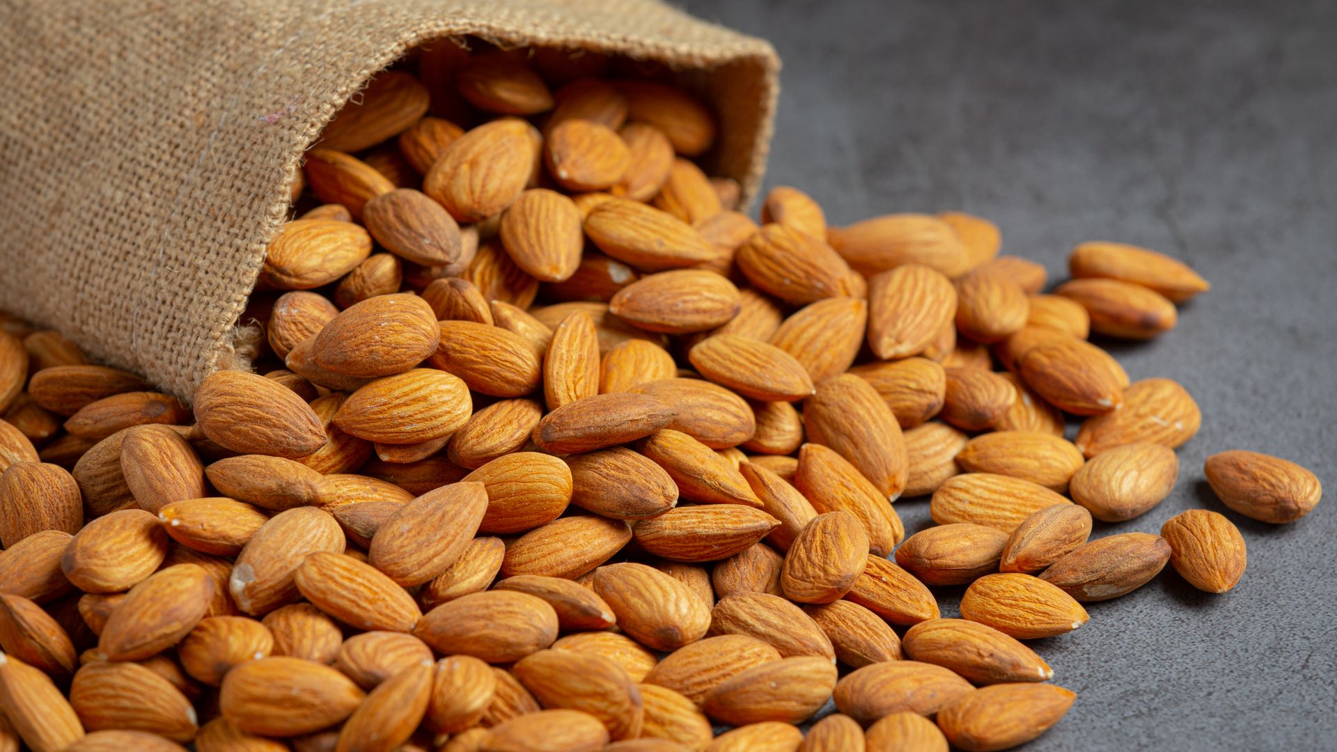 California almonds spilling from a jute sack